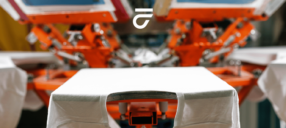 Shirt on screen printing press.