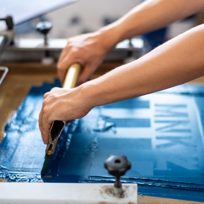 Woman transferring a print design onto a tshirt