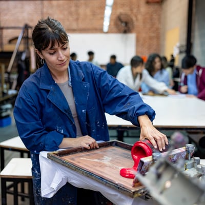 woman printing design onto shirt